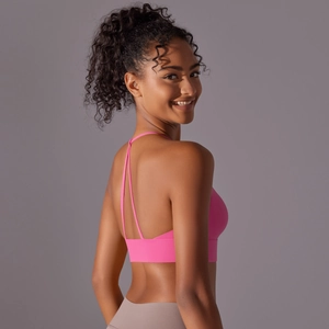 Detailed back view of pink yoga sports bra with thin Y-shaped cross straps and wide hem