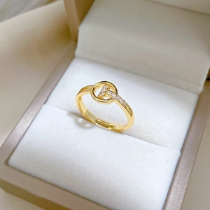 Adjustable gold T-shaped open ring with cubic zirconia stones in a jewelry box