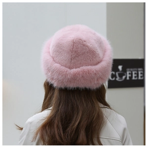 Detail of pink faux fur hat with soft plush texture and warm ear protection design