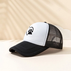 Detail of truck hat showing the black dog paw heart print and breathable mesh back