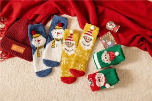 Detailed view of warm Christmas coral fleece socks with festive patterns and knit hat