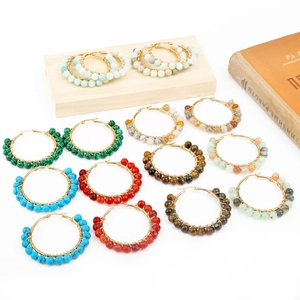 Flat lay of bohemian handmade wire-wrapped round earrings with natural stone beads