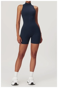 Detail view of navy blue yoga jumpsuit featuring a functional front zipper and seamless cut
