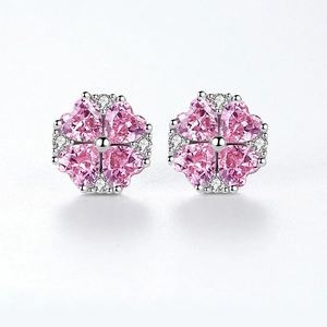 Macro detail of pink heart zircon flower studs with small crystals on silver base