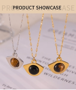Detail view of fan-shaped pendant necklaces with tiger eye stones and black gems