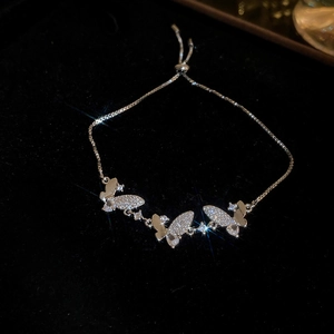 Detailed macro shot of silver butterfly bracelet with sparkling zircon stones and adjustable clasp