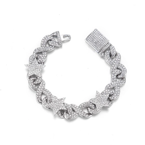 Macro shot of silver hip hop chain bracelet with star and infinity symbols
