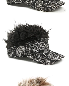 Detailed view of layered paisley print wig visors with thick black synthetic hair texture