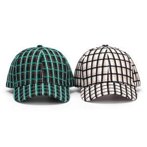 Close-up detail of vintage plaid patterns and textured fabric on baseball caps