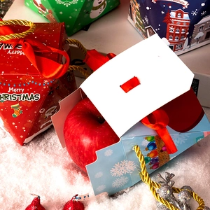 Pyramid-shaped Christmas gift boxes with festive illustrations and ribbon handles