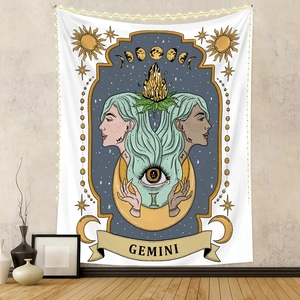 Detail of Gemini tarot tapestry with zodiac sun moon symbols and warm fairy lights