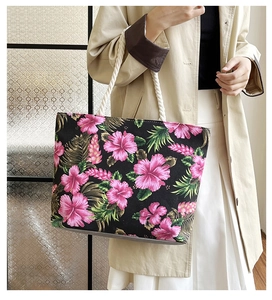 Detail of tropical floral canvas tote bag showing thick rope handles and ethnic print