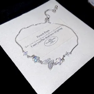 Elegant silver bracelet with zircon butterfly and opal flower charms, adjustable fit