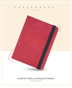 Detail of red frosted leather passport holder with elastic closure and embossed pattern