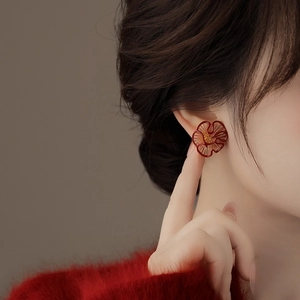 Elegant gold plated flower stud earrings with deep red enamel and hollow petal texture