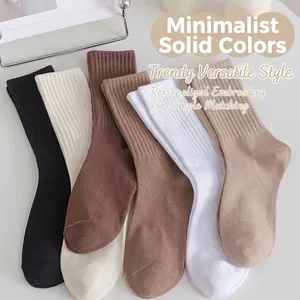 Cinq paires de chaussettes mi-mollet en coton côtelé aux tons neutres noir, blanc et brun