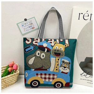 Close-up of safari canvas tote featuring cute animal print and striped woven handles