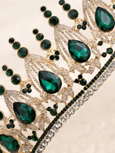 Detailed close-up of vintage bridal crown with green teardrop gems and crystals