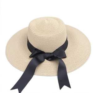 Elegant wide brim straw sun hat for women with a chic black ribbon bow decoration