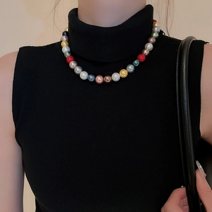 Close-up of vibrant multi-color pearl necklace with metallic luster on model neck