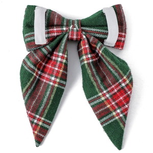 Detailed view of plaid dog bow tie with elastic bands for collar attachment