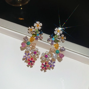 Macro shot of 18k gold plated floral earrings with colorful sparkling crystals