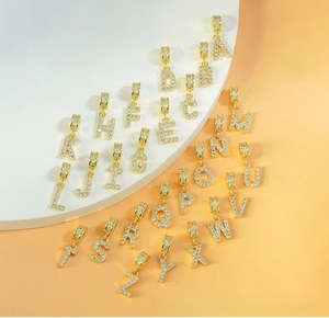 Detailed view of 26 gold-plated alphabet pendants with sparkling pavé cubic zirconia