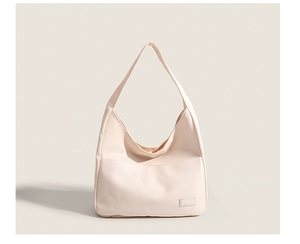 Detail of light beige crossbody bag with premium nylon texture and minimalist design