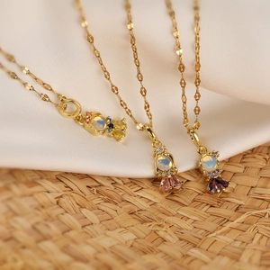 Gold plated candy pendant necklace with colorful zircons and opal center on white silk