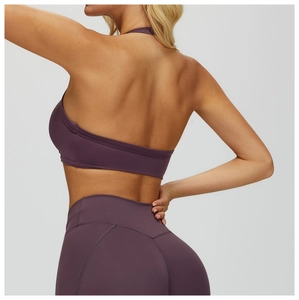 Detail of purple open-back halter yoga bra and high-waist leggings on a model