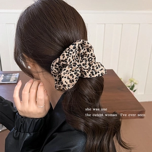 Vintage leopard print scrunchie styled on a brunette ponytail for a retro look
