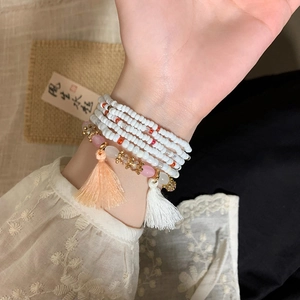 Bohemian multi-layer white seed bead bracelet set with pink tassel and gold accents