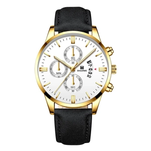 Detailed macro view of white watch dial showing sub-dials, calendar window and gold case