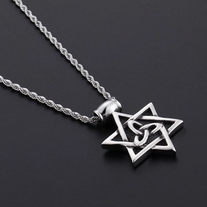 Macro detail of silver punk hexagram pendant with Celtic knot on a twisted rope chain