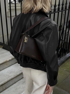 Women's dark brown textured leather shoulder bag with gold padlock and city style