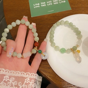 Detail of jade bead bracelets with green Ping'an buckle and Ruyi flower charms