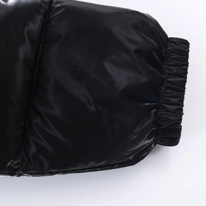 Detail of elastic cuffs on a shiny black water-resistant jacket with quilted stitching