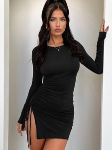 Detailed view of the black ruched side drawstring and slit on this slim fit bodycon dress