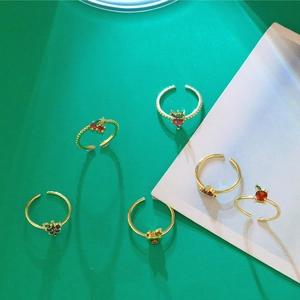 Detailed close-up of fruit-themed adjustable rings with colorful zircon fruit charms