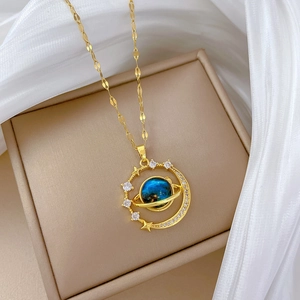 Macro view of a gold planet pendant with a blue sphere and sparkling crystals