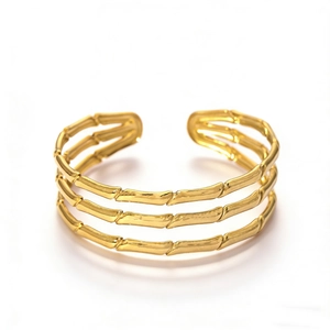 Elegant gold plated triple layer open cuff bracelet with bamboo texture on white background