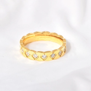 Macro shot of gold quilted pattern ring with micro-set white zircon stones details