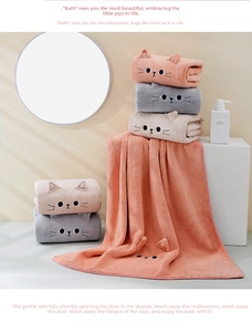 Close-up of cat-themed coral fleece towel set with 3D ears and embroidered faces