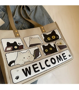 Detailed texture of canvas tote bag with cute cat graphic and Welcome text print