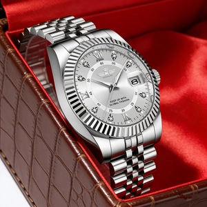 Detailed view of silver steel watch with fluted bezel and diamond markers in a gift box