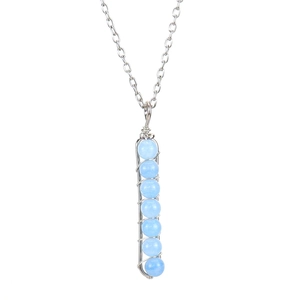 Detail of handmade silver wire wrapped U-shaped pendant with seven light blue beads