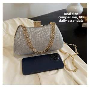 Silver sequin clutch bag with chain strap shown next to a smartphone for size comparison