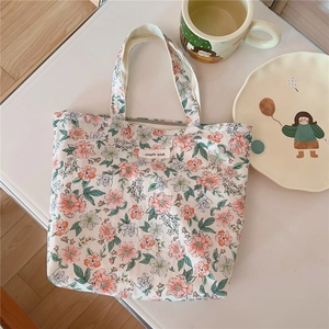 Detail of floral cotton tote bag featuring simple wish label and vintage flower pattern