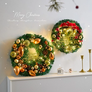 Lighted Christmas pine needle wreath with colorful ornaments and Merry Christmas sign
