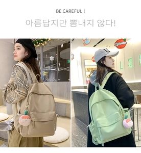 Detail of minimalist beige and light green waterproof nylon backpacks for school